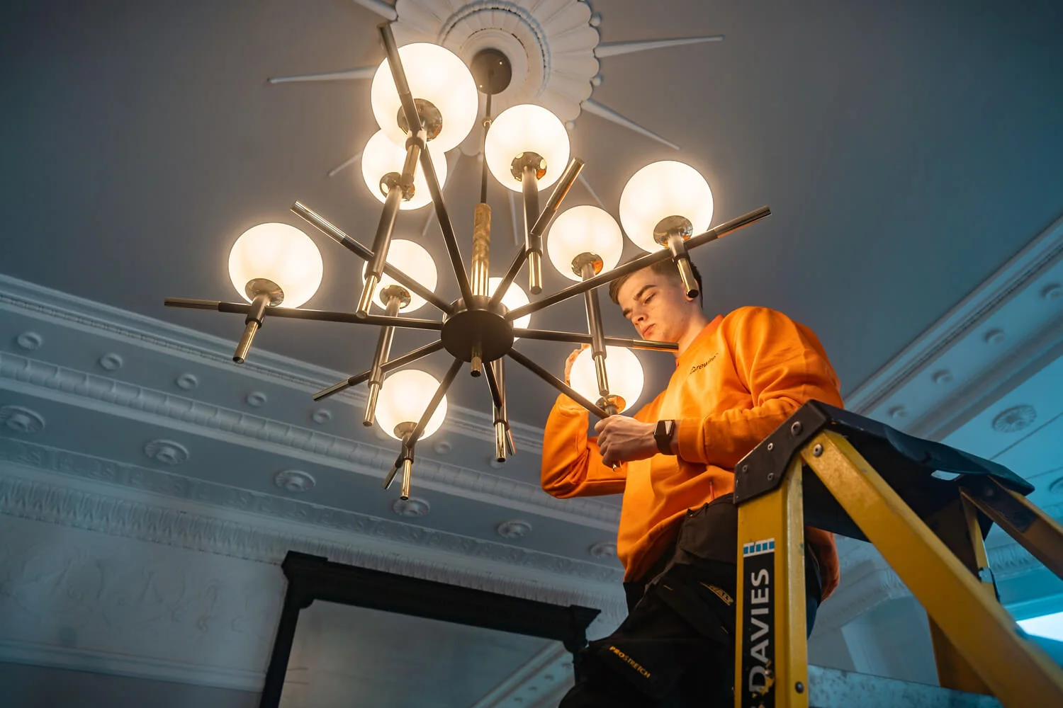 Rewire electrician adjusting internal lighting