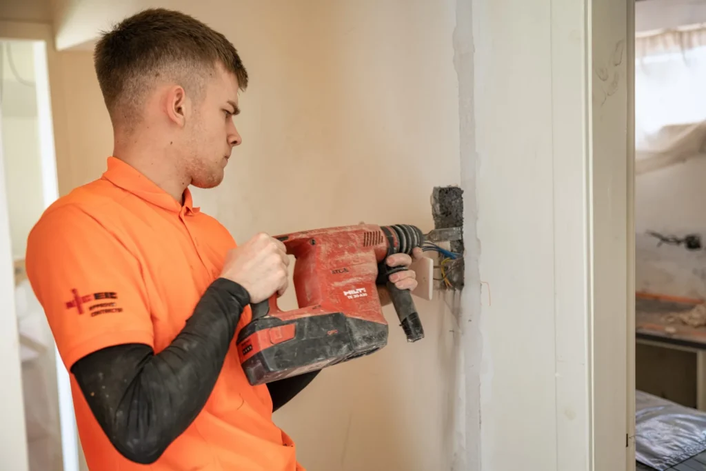rewire electrician cutting wall