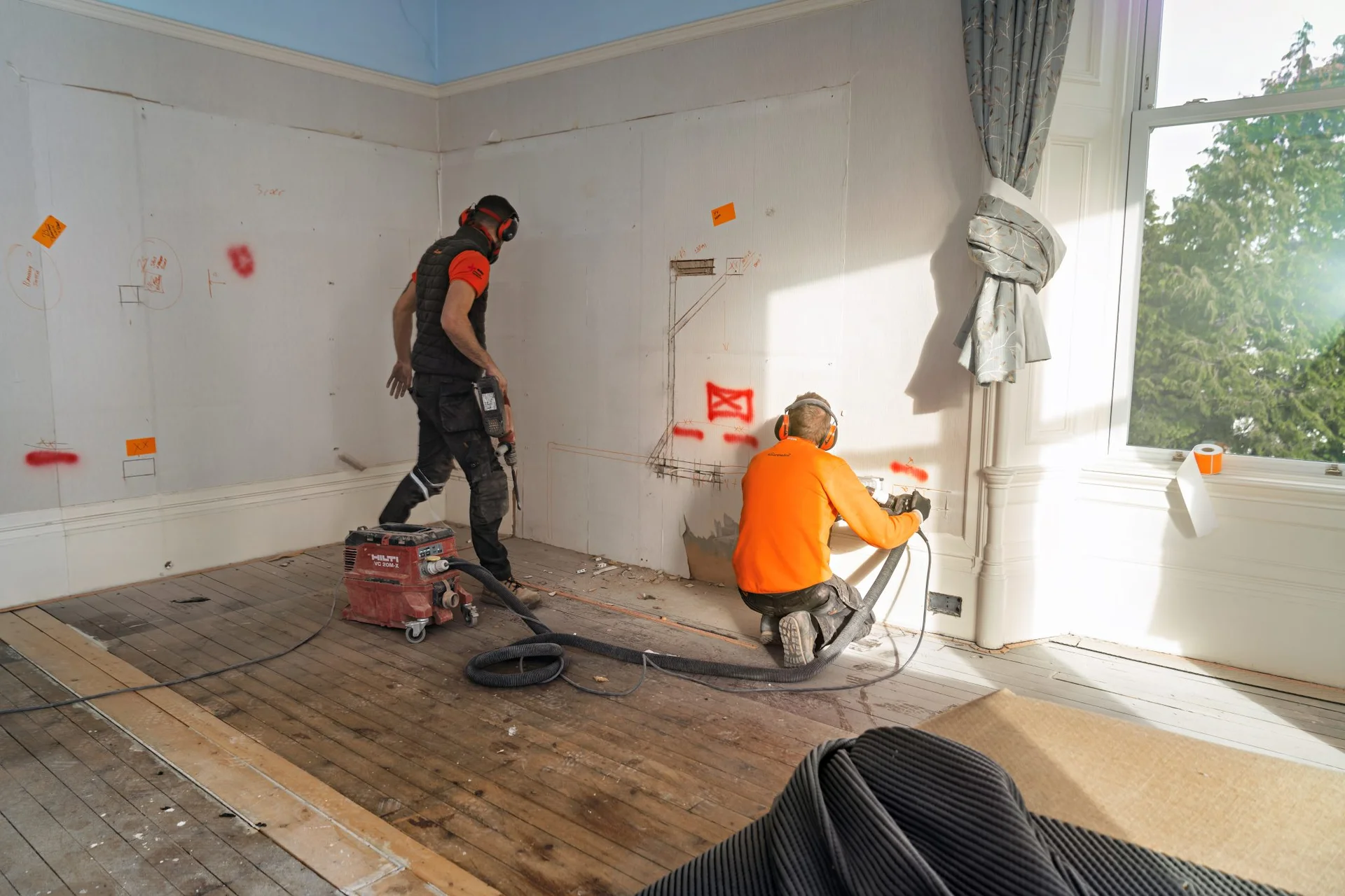 HomeRewire electricians cutting a wiring path in a Paisley rewire
