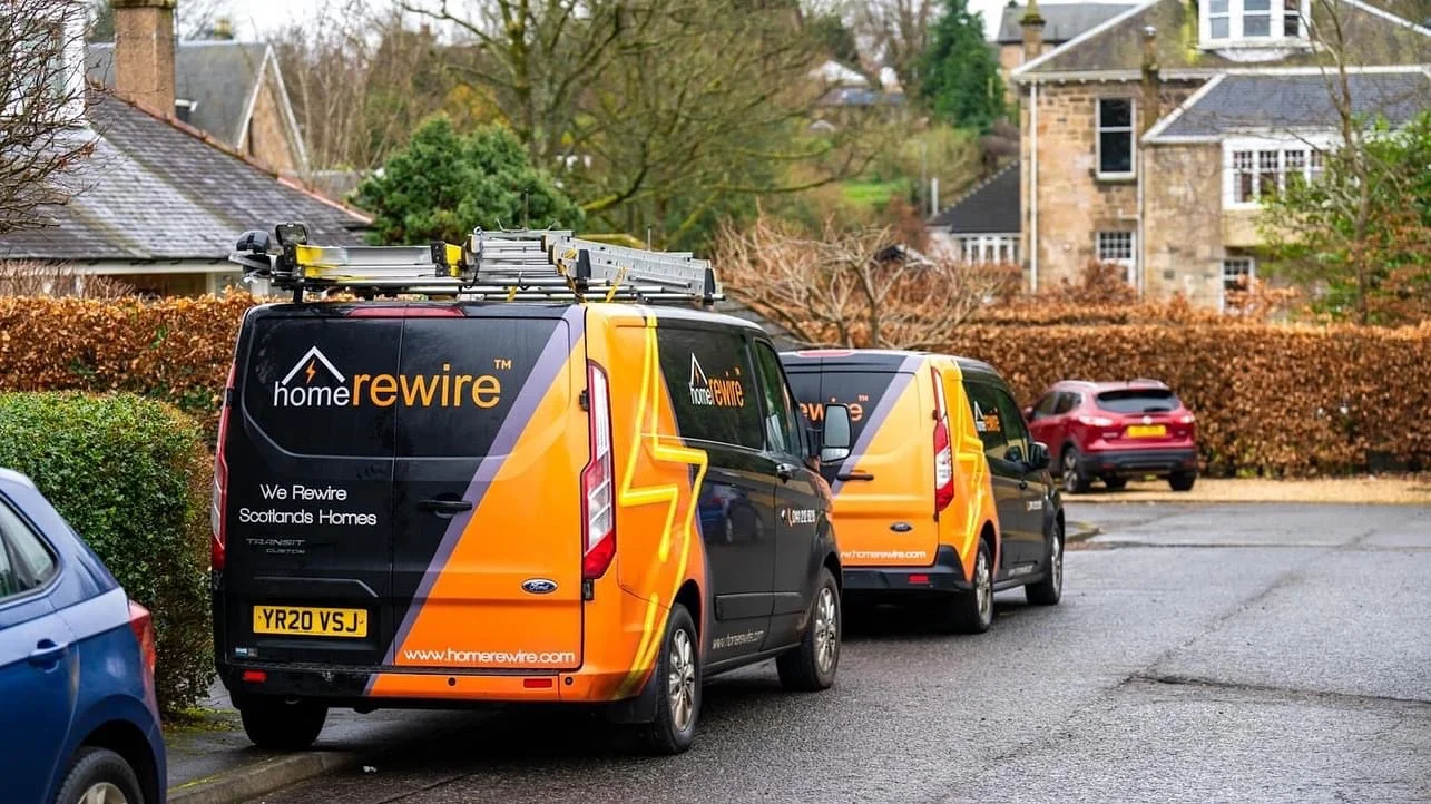HomeRewire vans parked outside a house rewire